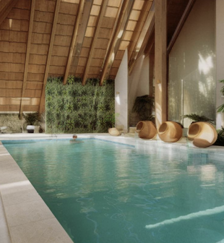 Modern indoor pool with a green wall - The Ophiuchus Healing Center